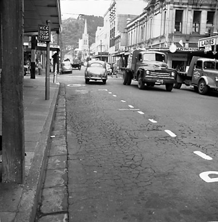 g. Views of streetscape, road surface, road works, machinery, motor vehicles, people, street signs, commercial buildings, Foresters Arms Hotel