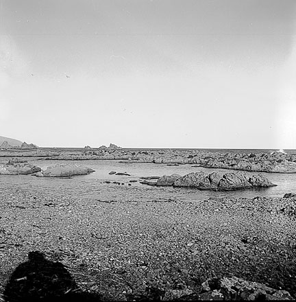 c. Views of coastline from beach, Taputeranga Island in background