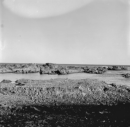 f. Views of coastline from beach, Taputeranga Island in background