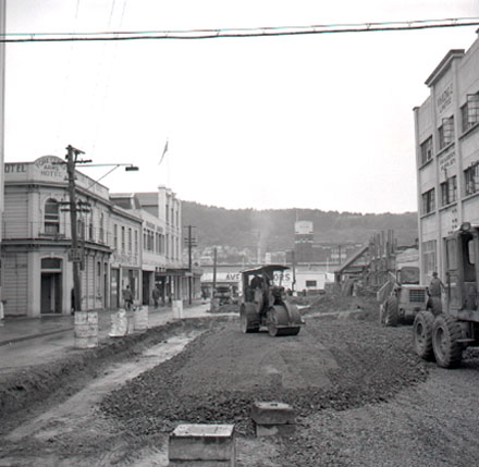 a. Road works in foreground with Foresters Arms Hotel in background. Workmen using grader