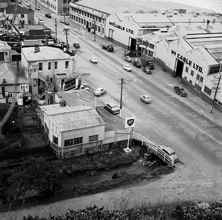 b. Views of the commercial / industrial area around the Hutt Road and Kaiwharawhara Road intersection. Warehouses, dwellings, BP Service Station, motor vehicles, Kaiwarra Wool Store, Wm Cable Ltd