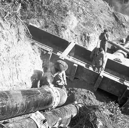 a. Karori Reservoir area, workmen installing pipes