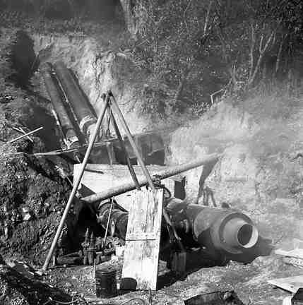b. Karori Reservoir area, workmen installing pipes