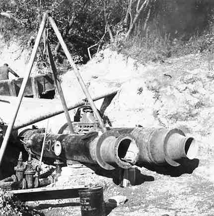 c. Karori Reservoir area, workmen installing pipes