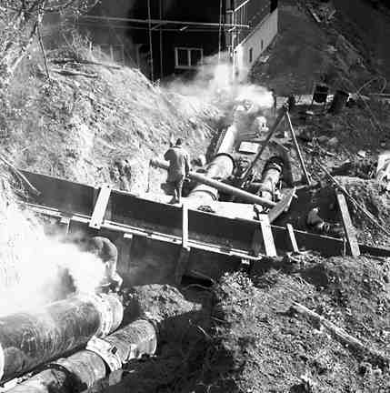 d. Karori Reservoir area, workmen installing pipes