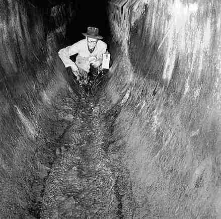 a. Workmen inspecting inside of drains