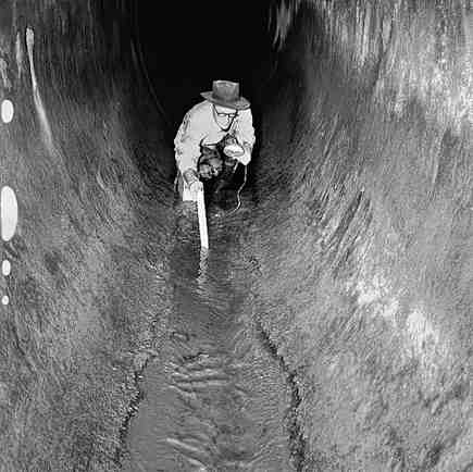 b. Workmen inspecting inside of drains