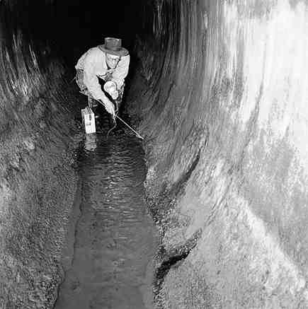 c. Workmen inspecting inside of drains