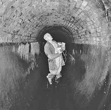 e. Workmen inspecting inside of drains