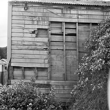 g. 9 Mein Street, a single-storey wooden building