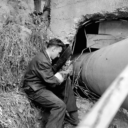 c. Workman welding pipes