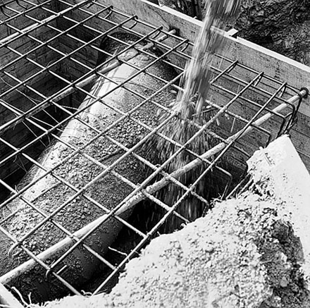 b. Concrete being poured onto reinforcing
