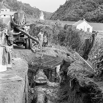 a. Karori Reservoir area, workmen installing pipes
