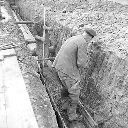 a. Workman digging trench