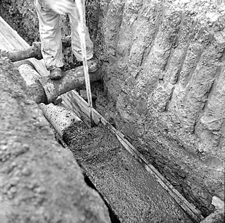 b. Workman digging trench