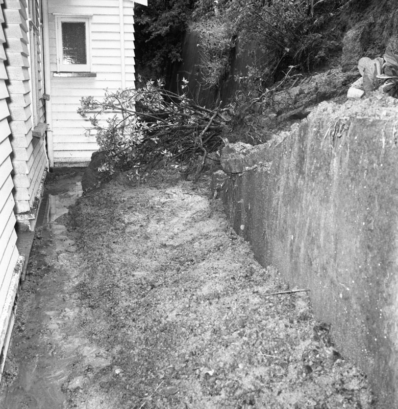 e. No 152 Barnard St. scouring of bank and rubble left by downpour