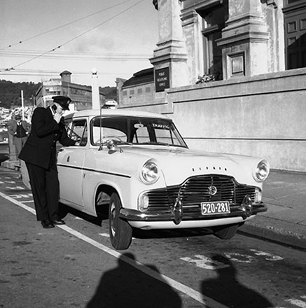 a. Traffic Inspector Boswell with Patrol Car, talking on car phone, Mercer Street