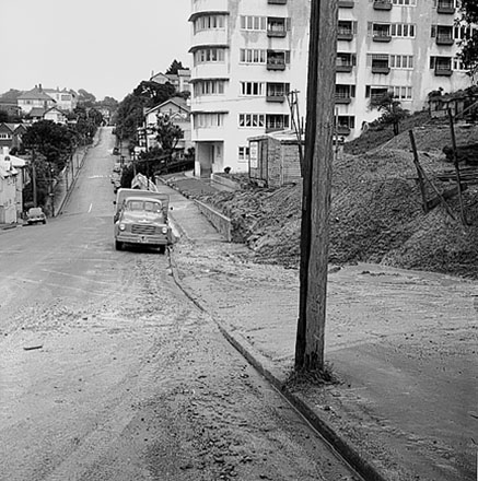 c. Streetscape showing damage to foot path caused by heavy machinery, multi storey apartment block at 312-320 The Terrace