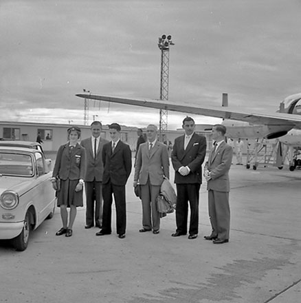 c. Group of people standing in front of an aeroplane, includes Mayor Frank Kitts, Traffic Department Supervisor Anderson and Deputy Boyden