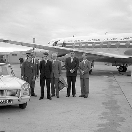 f. Group of people standing in front of an aeroplane, includes Mayor Frank Kitts, Traffic Department Supervisor Anderson and Deputy Boyden