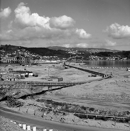 a. Area of reclamation, the Municipal Power Station is on the left. Looking across to Evans Bay Parade and residential area