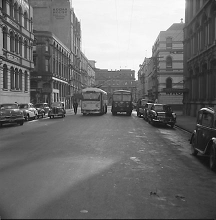 b. Trolly bus attempting to pass a diesel bus. Chews Lane on the left, Kodak Building in the background. Motor Vehicles