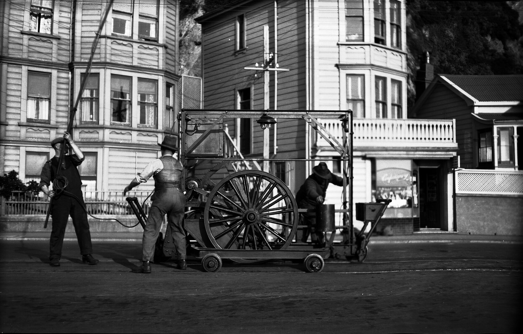 Oriental Parade, three workmen working with Reciprocating Grinder on newly laid tram rails