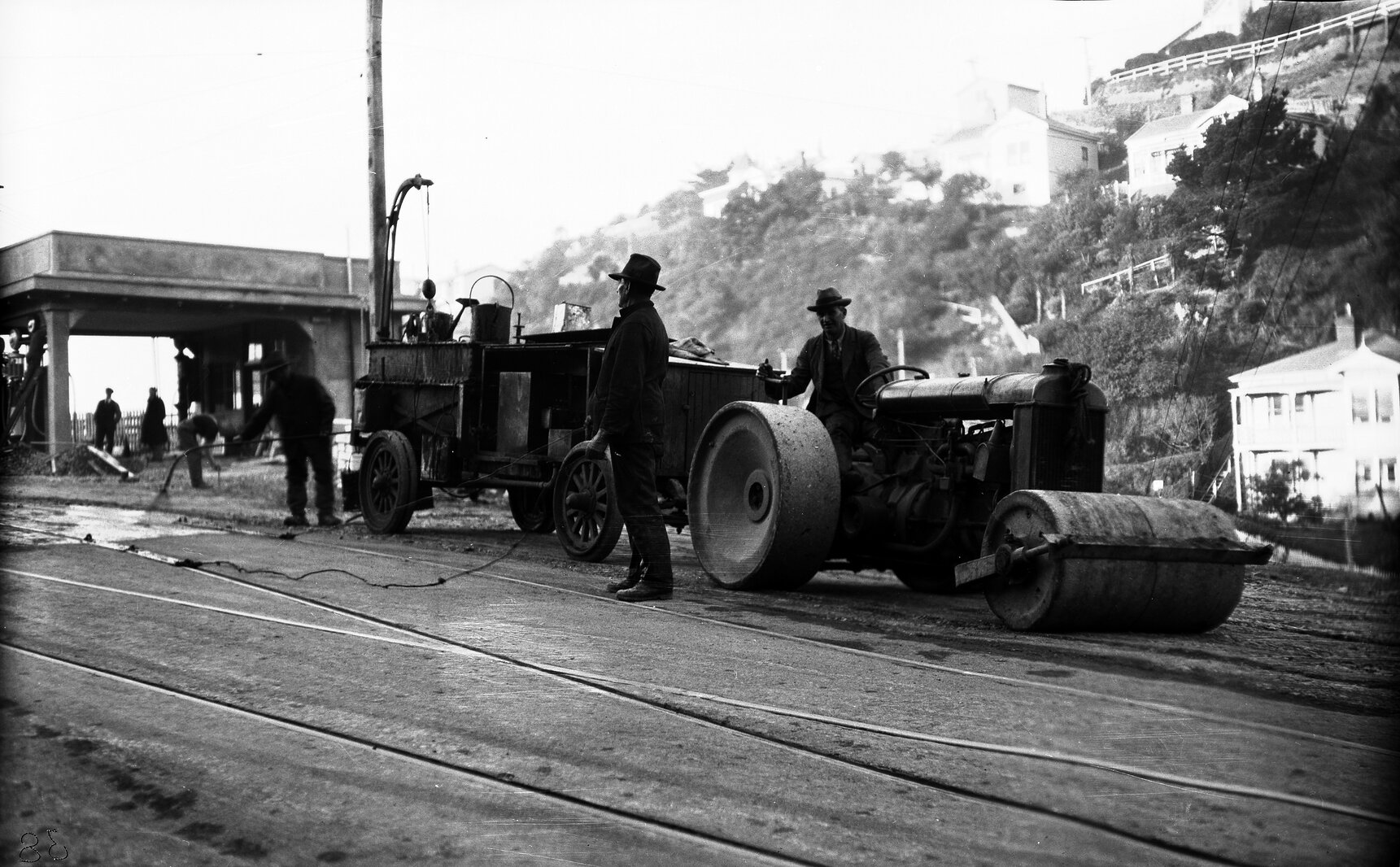 Glenmore Street, workmen operating the Cold Fix Spraying Outfit and Track Roller on newly laid tram rails