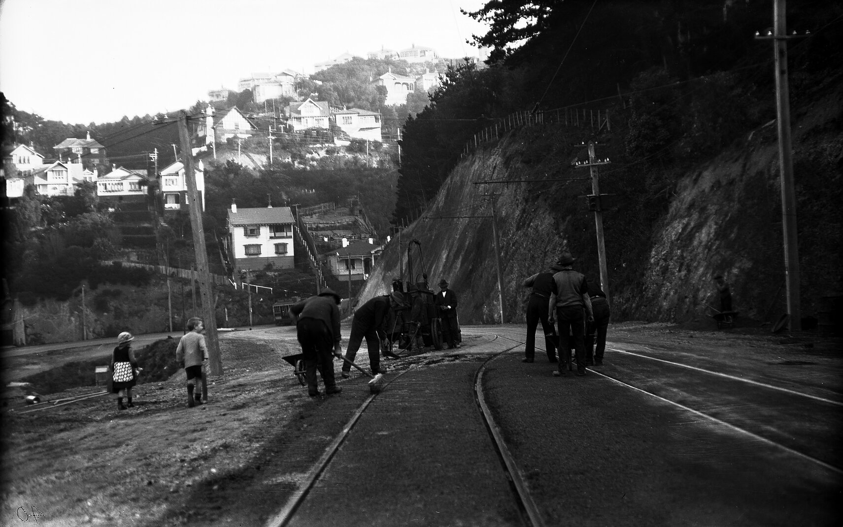 Glenmore Street, workmen operating the Cold Fix Spraying Outfit and Track Roller and finishing surface of completed work on newly laid tram rails