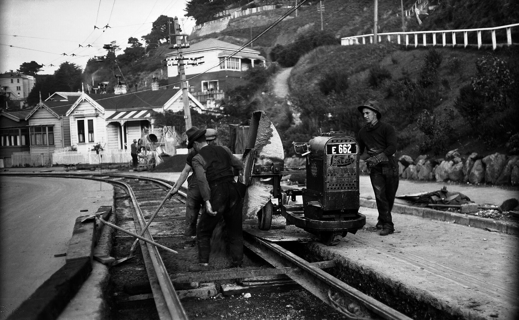 Aro Street, workmen pouring concrete out of tipper on Lister Truck, between newly laid tram rails