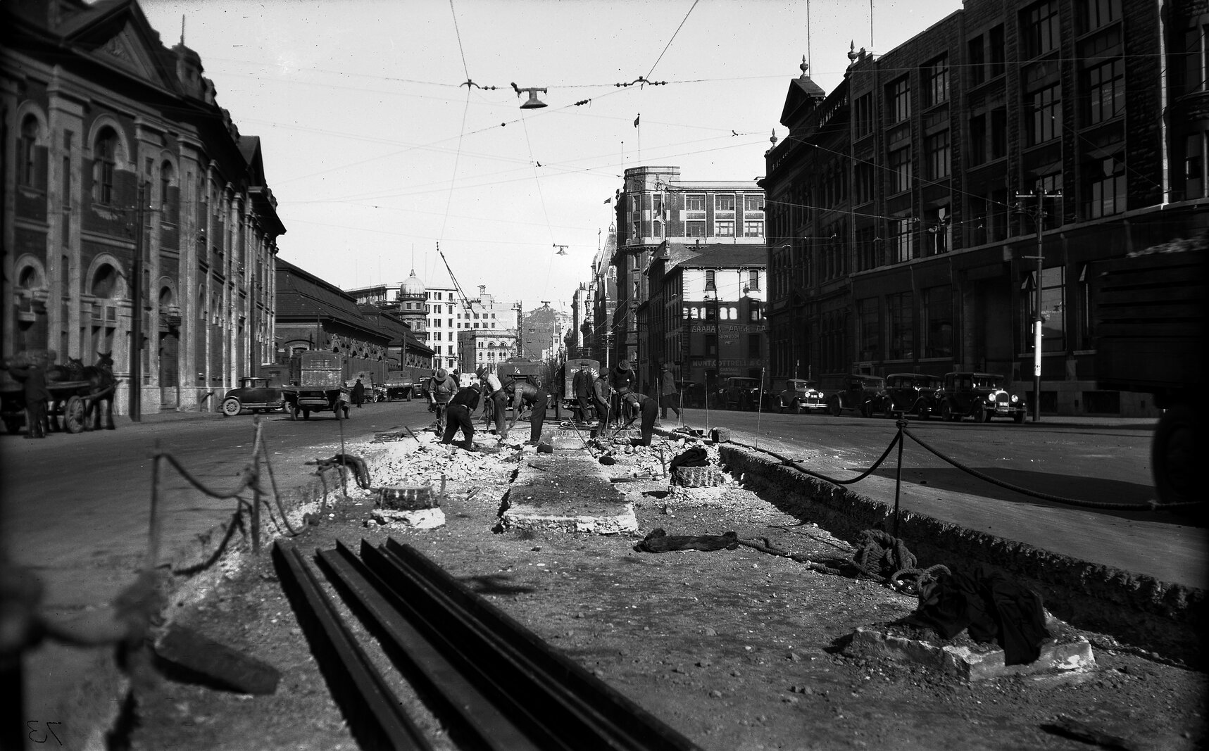 Customhouse Quay, workmen preparing road for laying of new tram rails