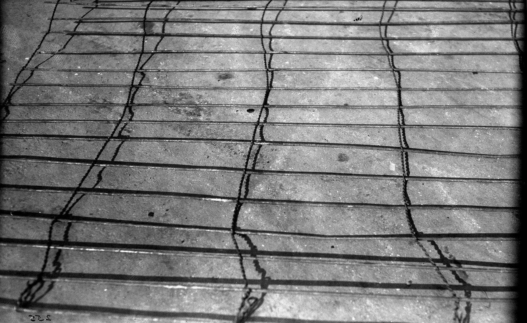 Detail of reinforcing mat, 1/4 inch rods, 4 inch apart with twisted 1/8 inch steel wire 1 foot 3 inch apart