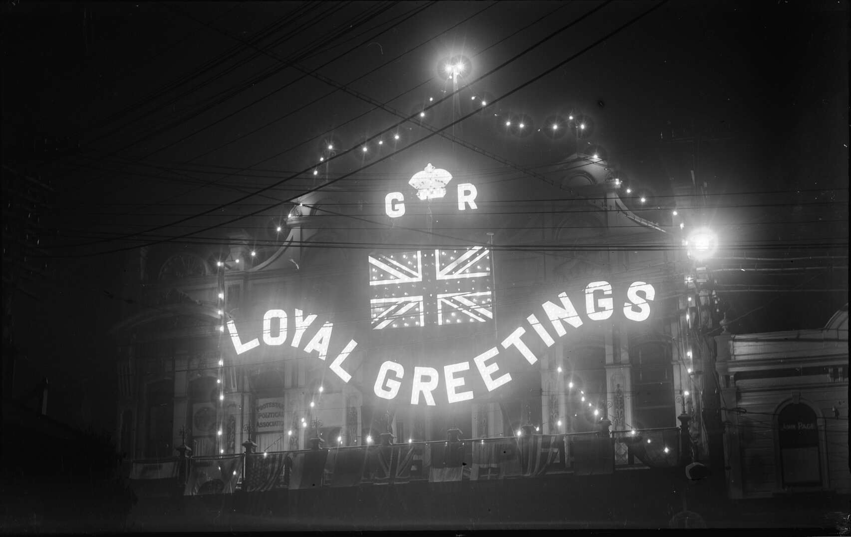 Building decorated with lights and flags to commemorate the Prince of Wales visit