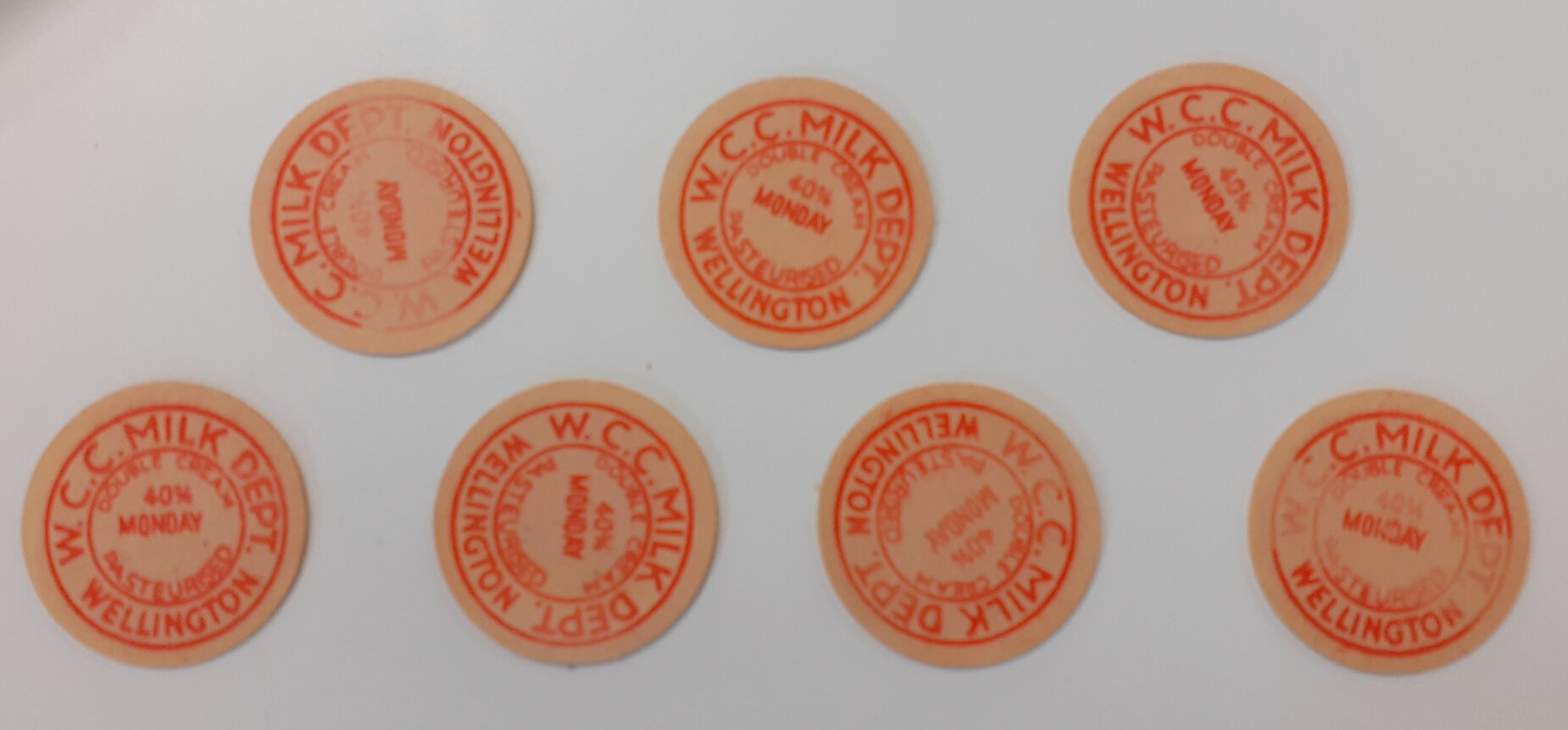 Milk bottle caps in cardboard cylinder