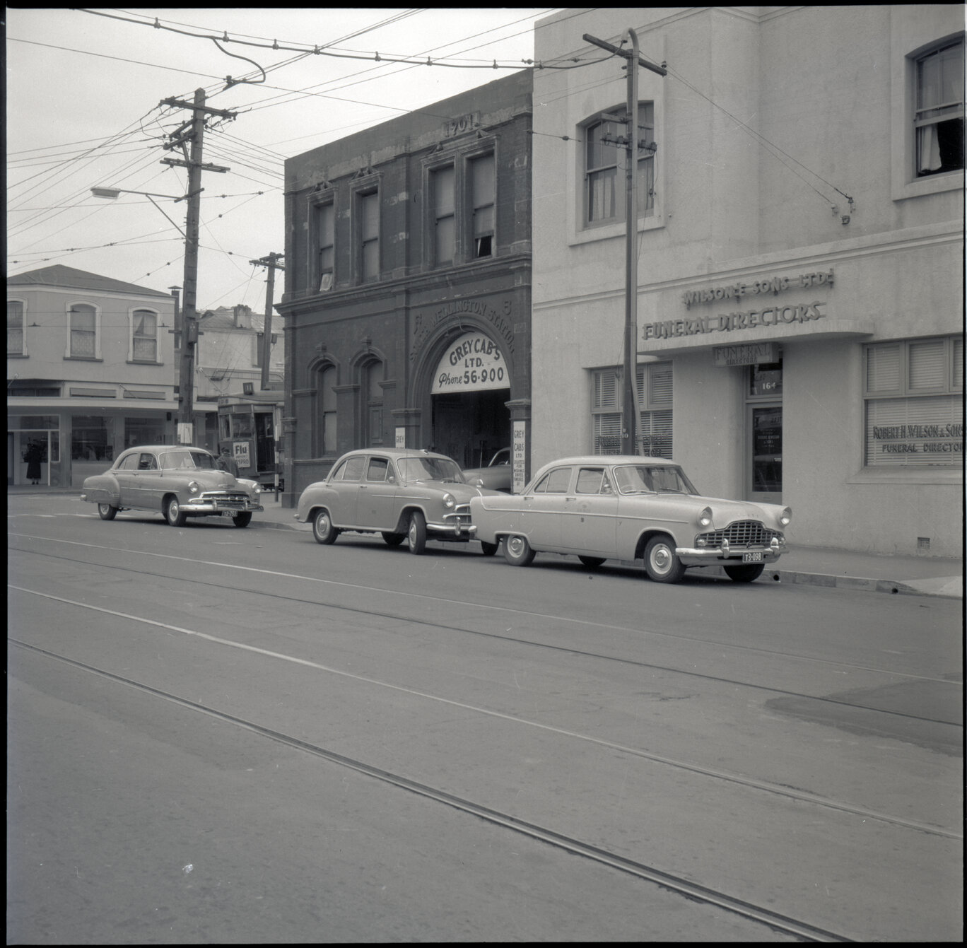h. Grey Cabs, taxi / motor vehicles parked outside office and Wilsons and Sons Funeral Directors on Adelaide Road