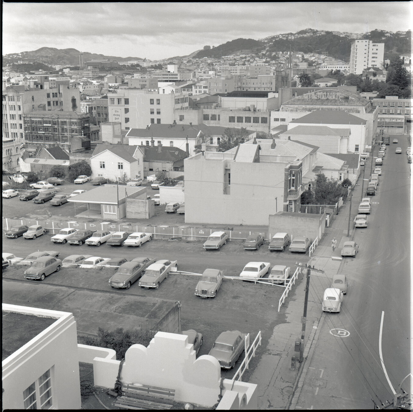 f. Elevated view of motor vehicle parking and dwellings on Boulcott Street - Te Aro in the background