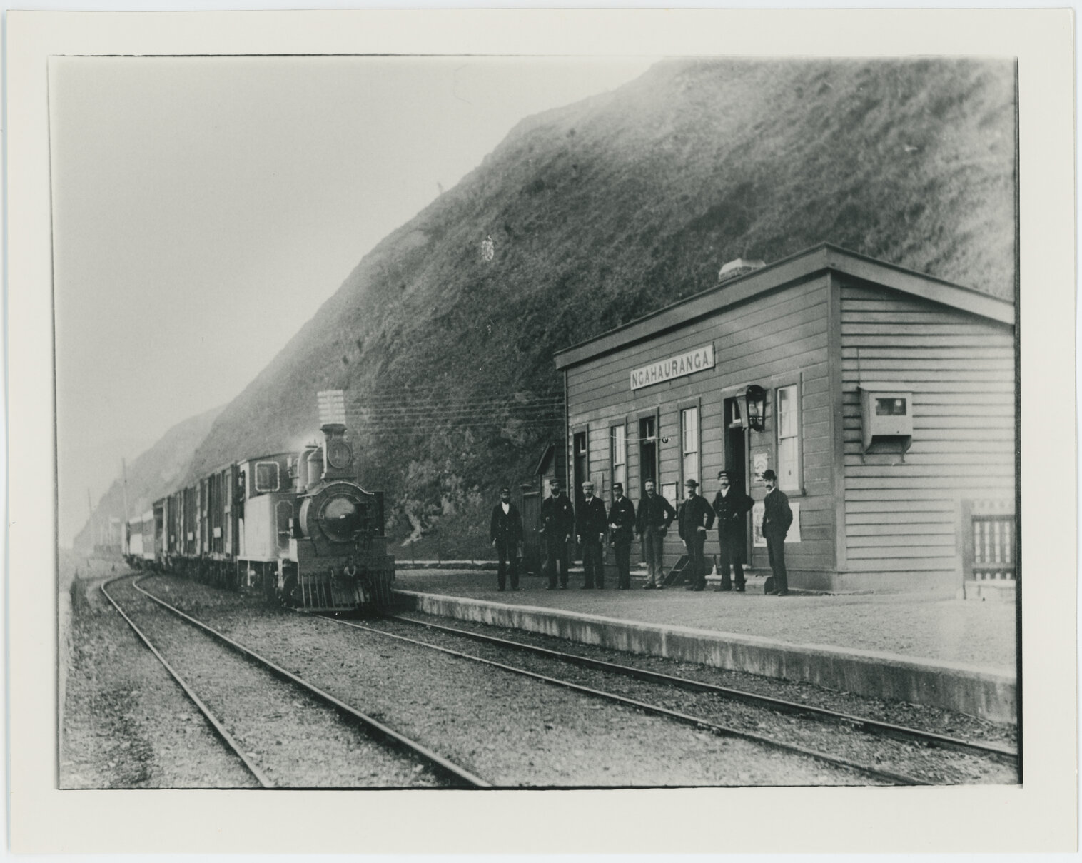 Men in front of train at Ngahauranga [Ngauranga] Railway Station
