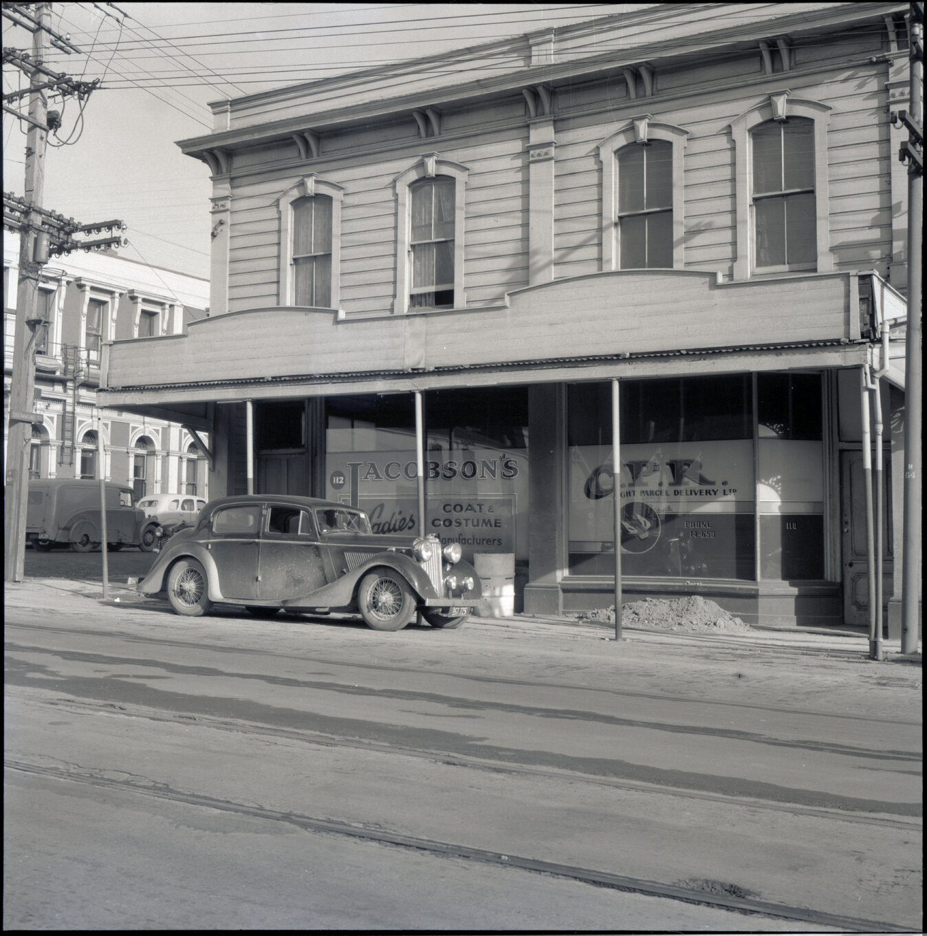 c. Two storey wooden building on the corner of Drummond Street and Adelaide Road, used for retail purposes - Jacobsons Laidies Coats and Costume, C P R light parcel delivery