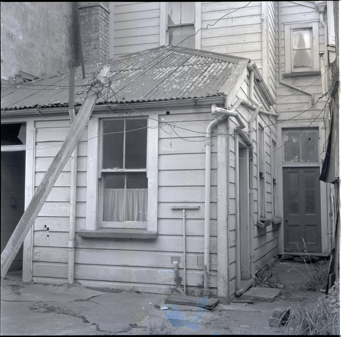 b. Sub-standard building, 76 Adelaide Road, a two story wooden building next to the Adelaide Road Sub Station