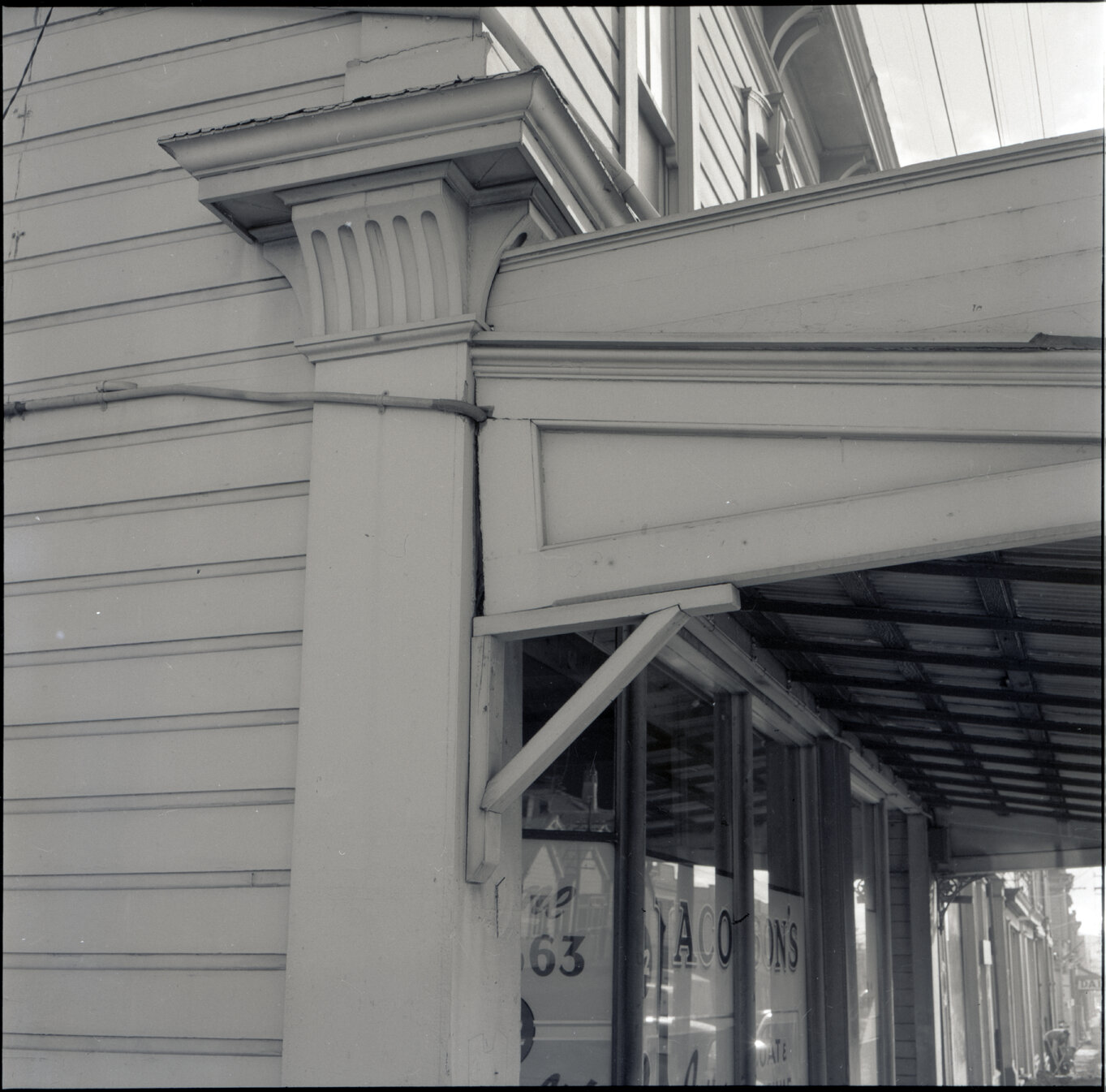 b. Two storey wooden building on the corner of Drummond Street and Adelaide Road, used for retail purposes - Jacobsons Laidies Coats and Costume, C P R light parcel delivery