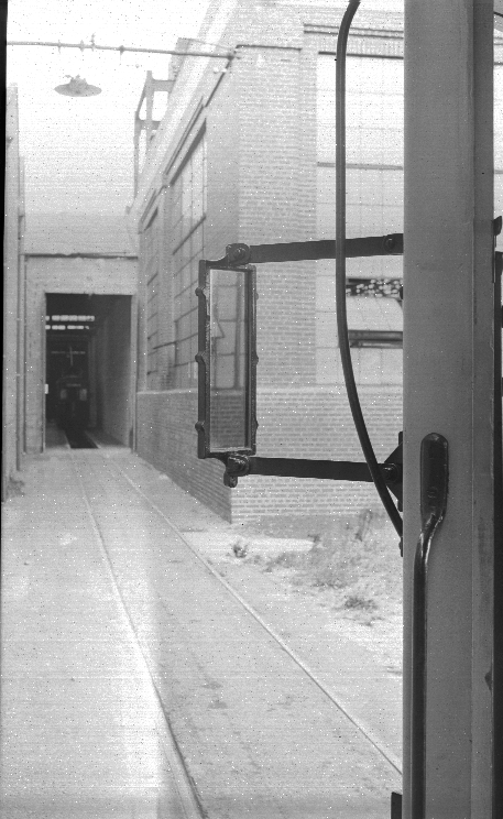 Rear view mirror attached to exterior of tram