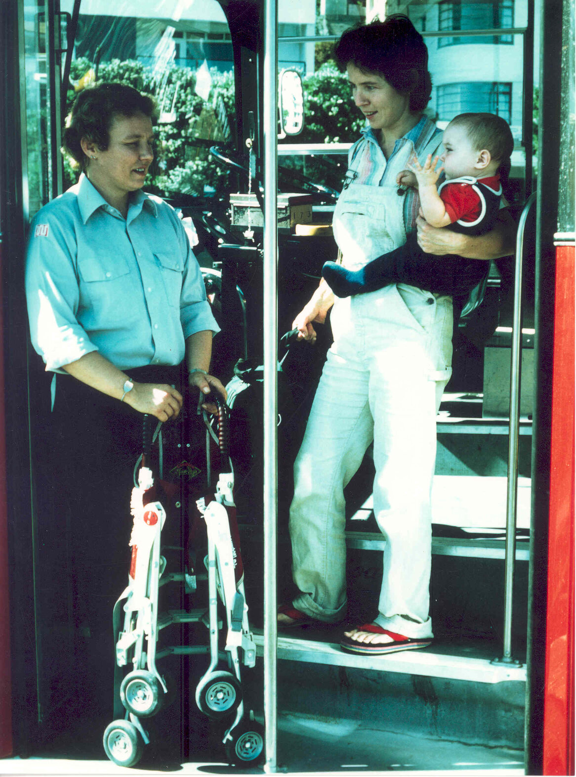 Bus driver aiding passenger with pram