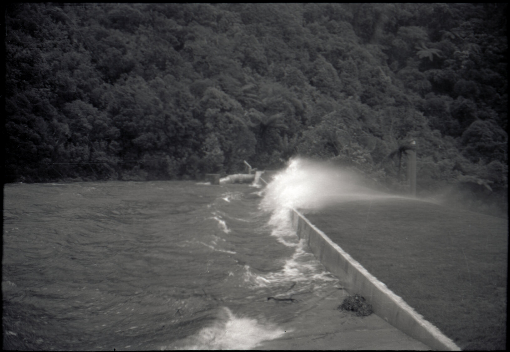 Photograph of water blowing over lower Karori dam during the Wahine storm