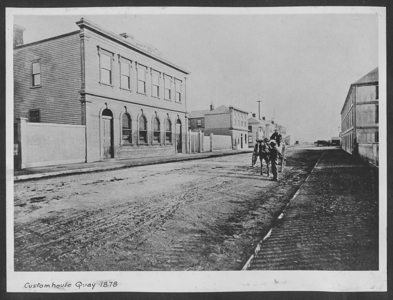 The wooden two-storey building on the right is the Bank of Australasia (1835)