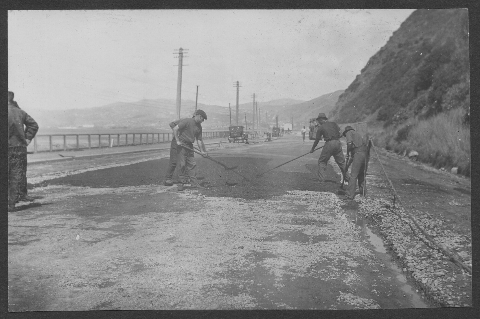 Workmen are laying new road seal on Hutt Road.