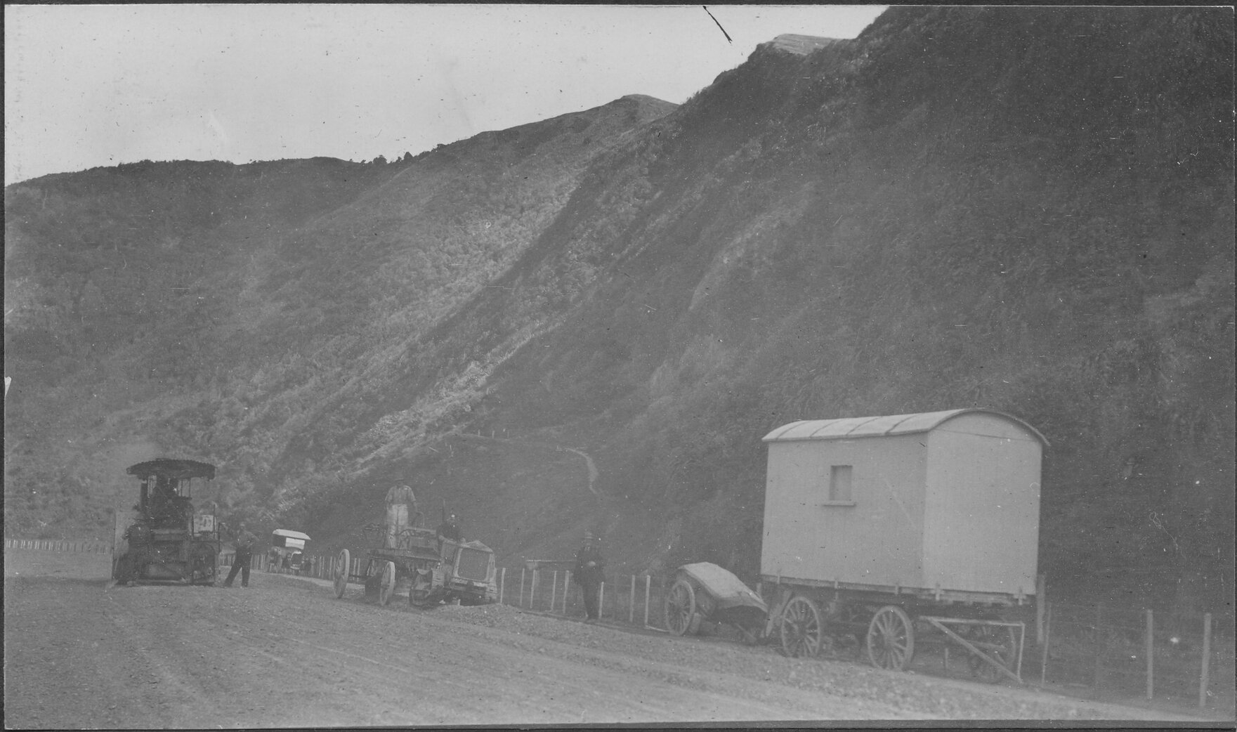 Elevated view of workmen in process of sealing Hutt Road.