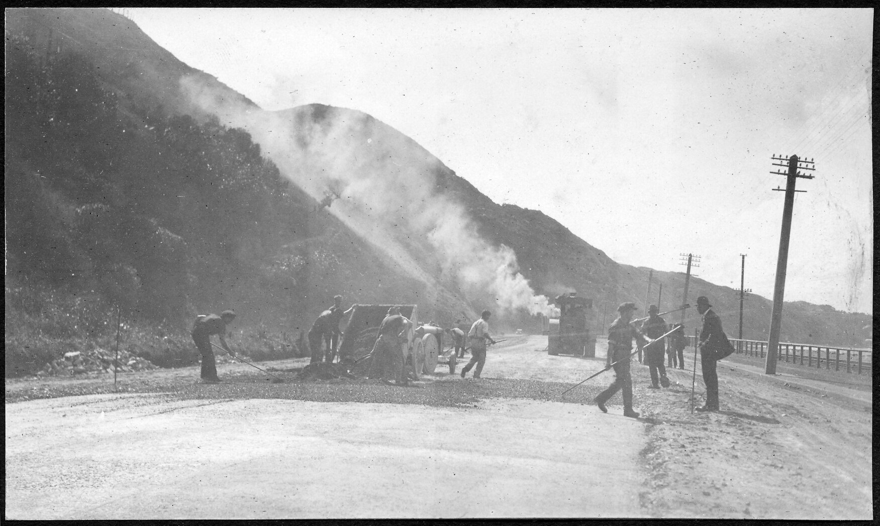 Machinery producing asphalt for new road sealing.