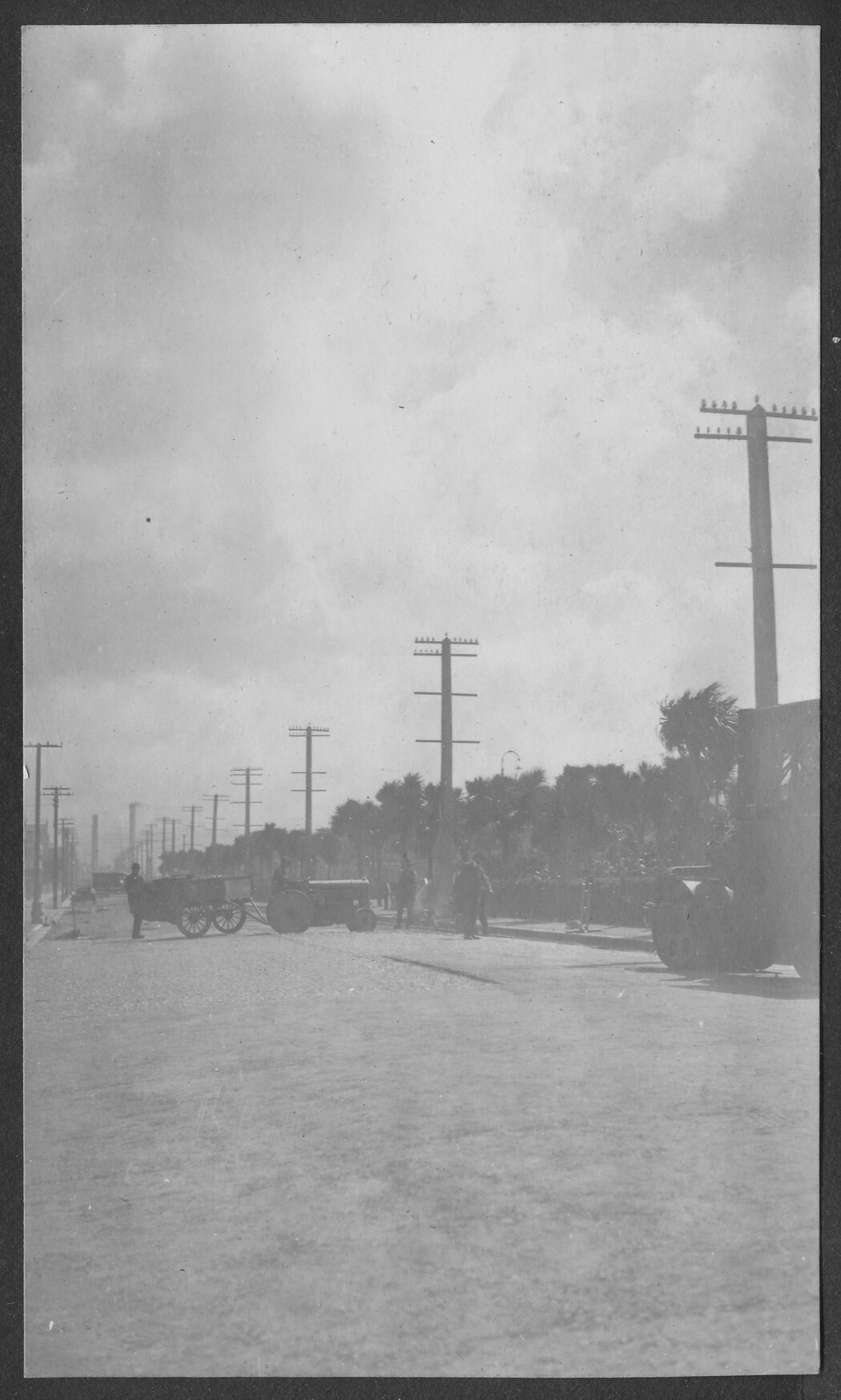 Looking north along Cambridge Terrace, road sealing is in progress. The Destructors smoke stacks can be seen in the background.