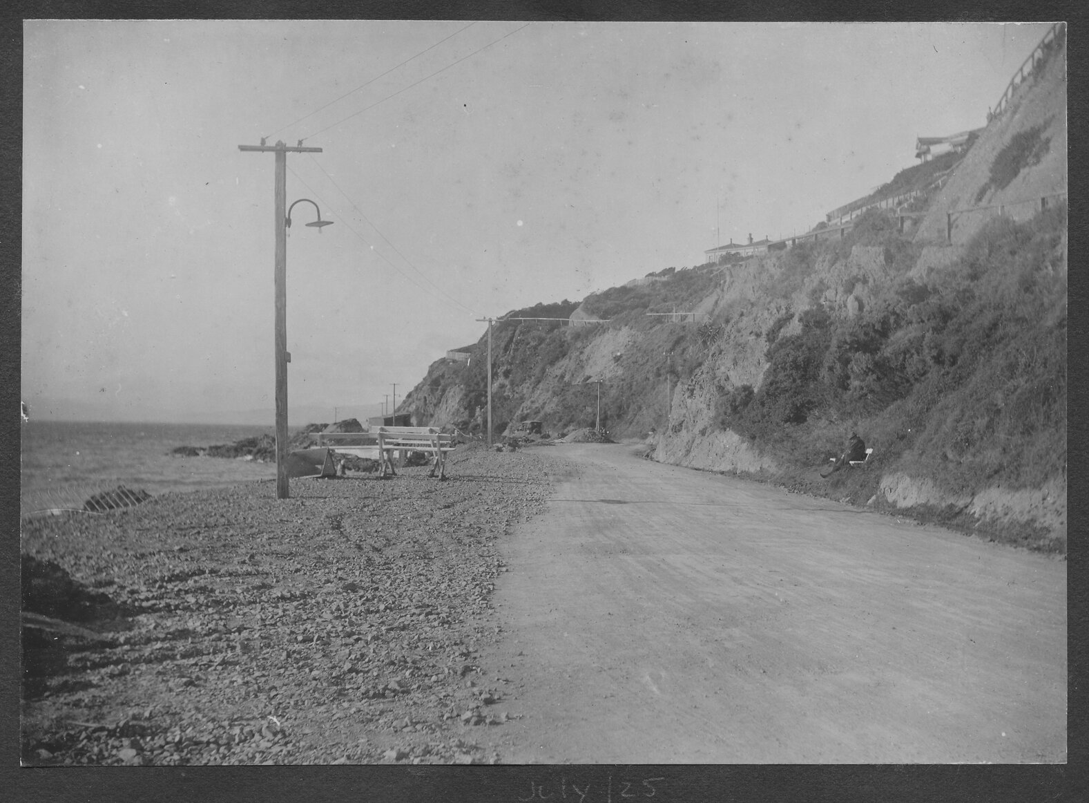 Unsealed road and prior to constrcution of seawall, looking towards Point Jerningham.