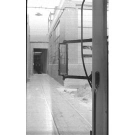 Rear view mirror attached to exterior of tram